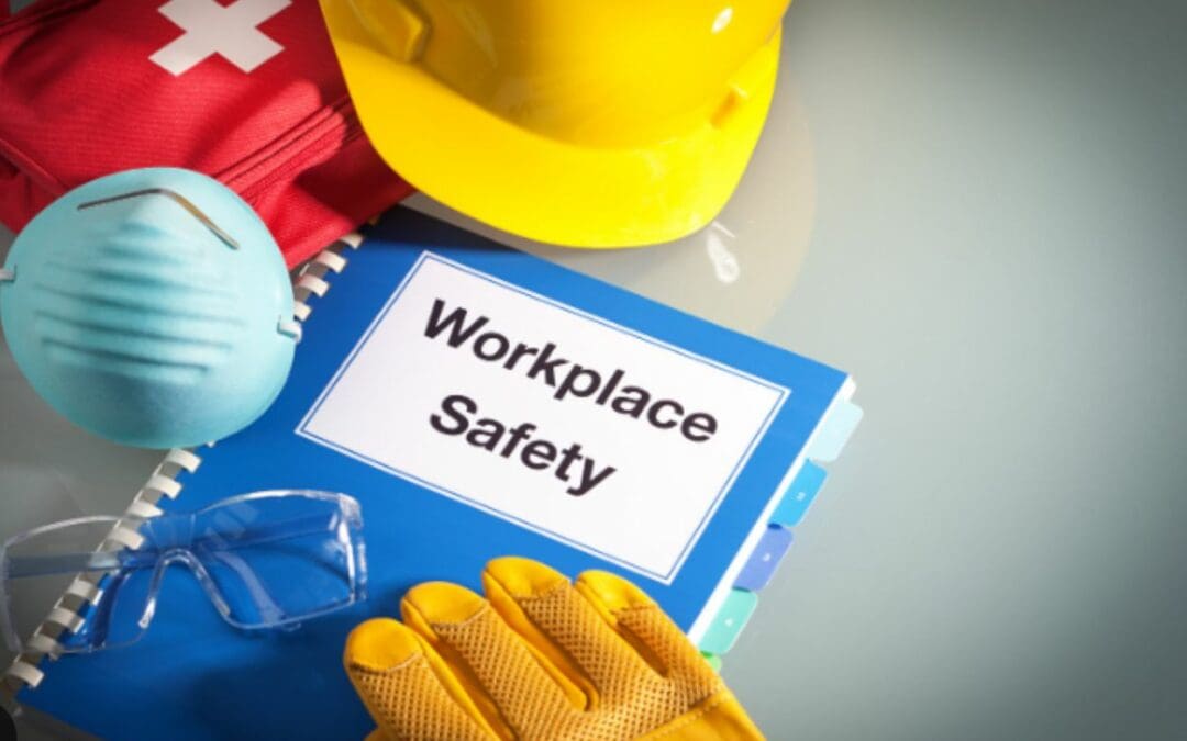 Workplace Safety binder among other safety items on a smooth surface